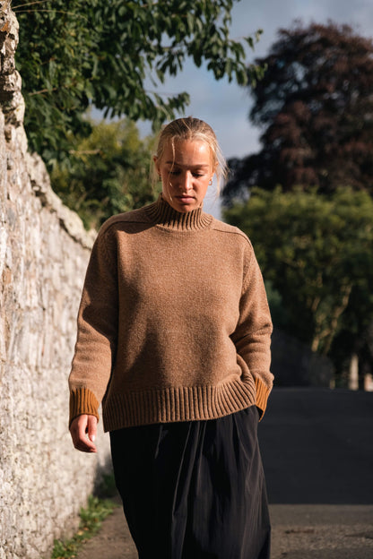 Maree knit is made with the finest Scottish spun lambswool. Knitted in a chunky luxurious 4 ply yarn with a funnel neck, contrast cuffs and a boxy, oversize fit. Traditionally made with fully fashioned knitting techniques and linked together by hand. Crafted within 80 miles of our design studio in the Scottish Borders.